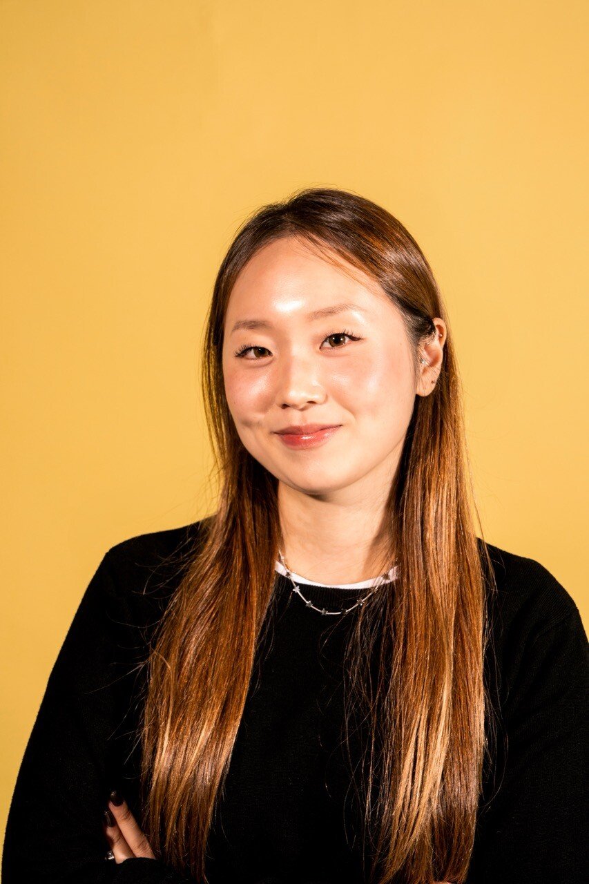 Hailey SoJeong Kim against a warm yellow background
