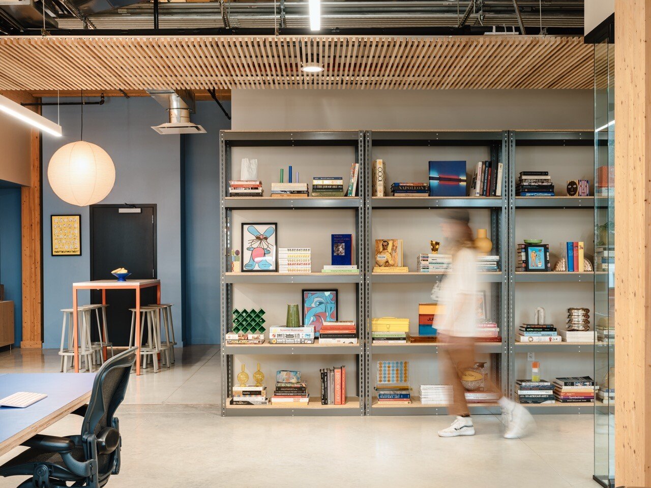 Koto office with industrial shelving, books and artwork