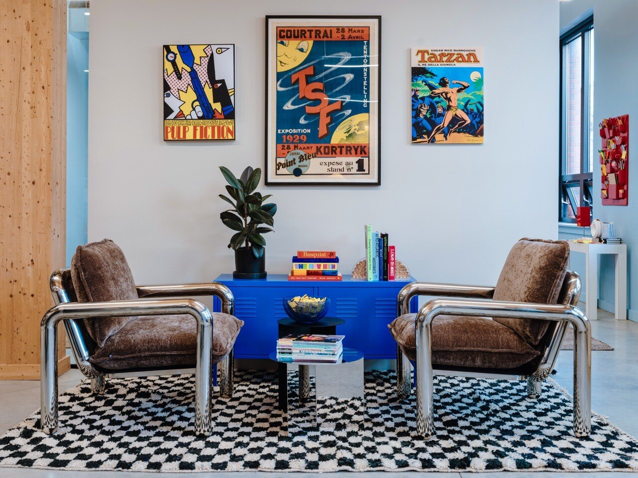 Koto lounge with two brown chairs and a bright blue table