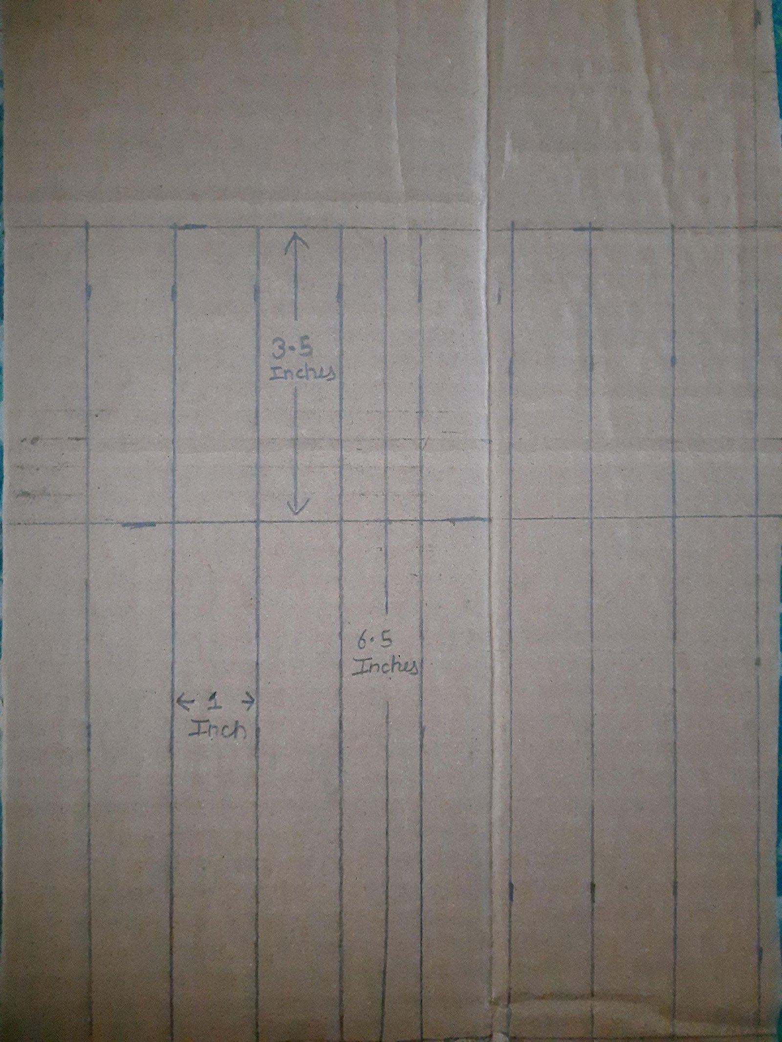 Repeated one-inch cardboard rib outlines measured and drawn before cutting