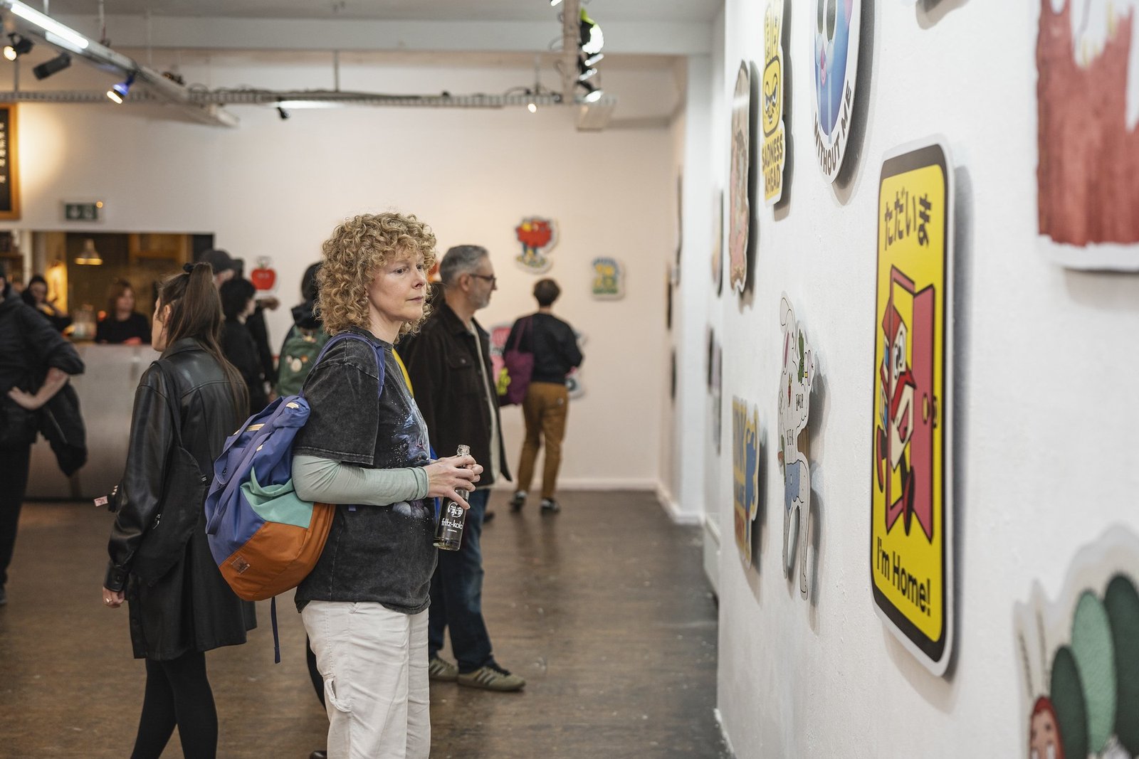 A visitor viewing character artwork in a Pictoplasma gallery