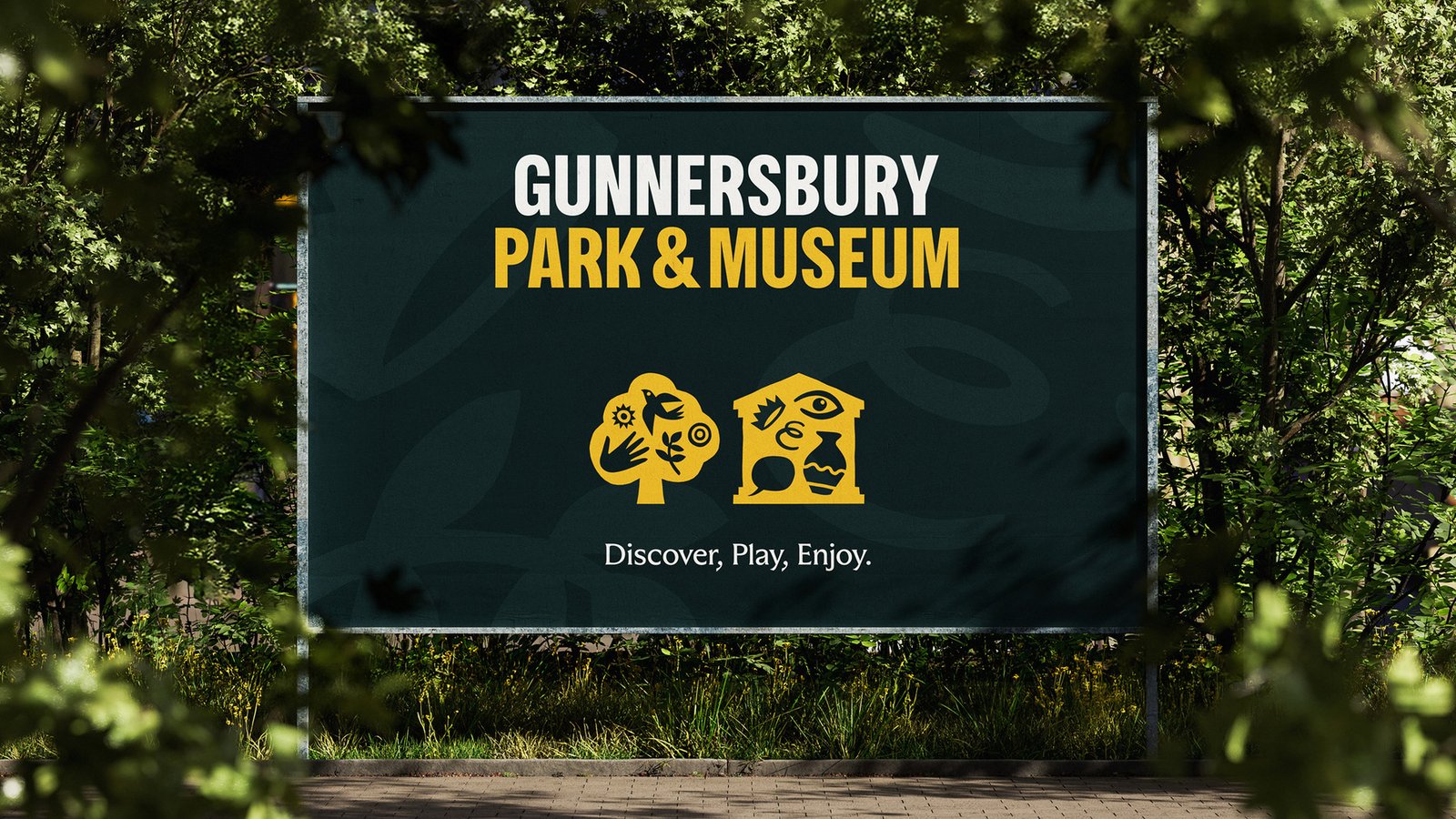 Gunnersbury Park and Museum signage surrounded by foliage, featuring yellow icons and the tagline ‘Discover, Play, Enjoy’