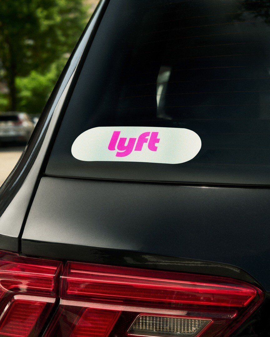 Lyft logo sticker displayed on a car window