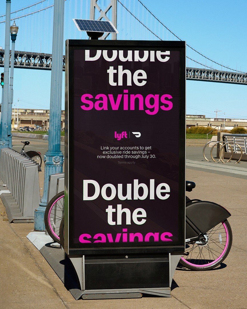 Lyft Double the Savings street billboard near a bridge