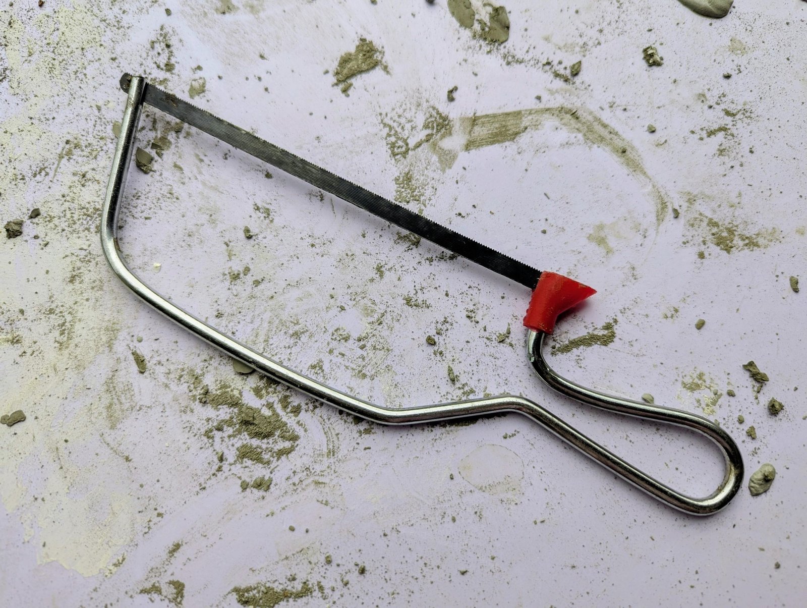 Small hand saw used to cut the ping-pong ball mold