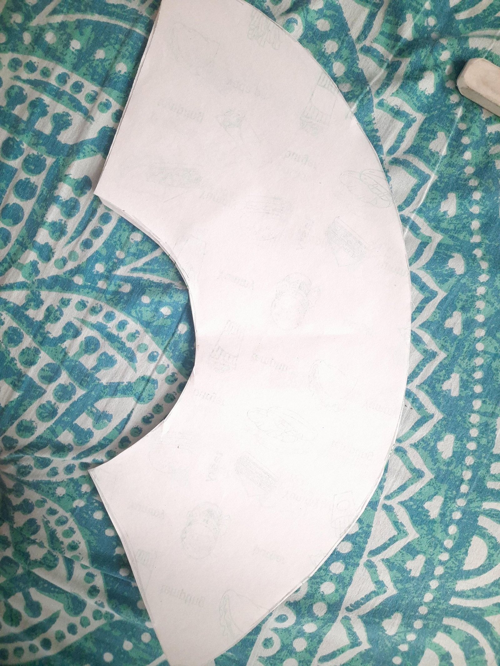 A large white fan-shaped paper sheet cut to fit the open rib frame