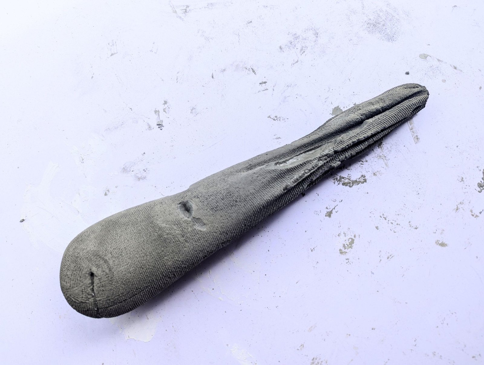 Cured mushroom stem still enclosed in the sock mold