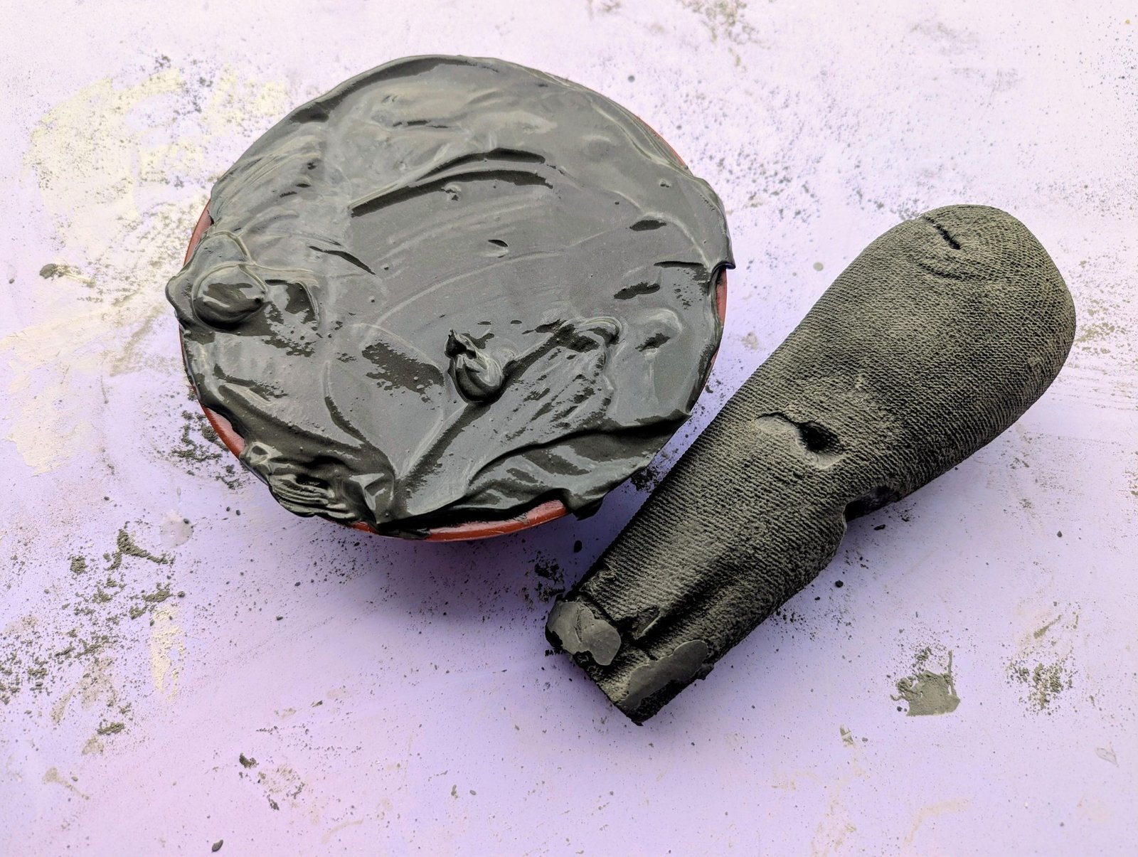 Cured cement stem positioned beside the freshly filled cap mold
