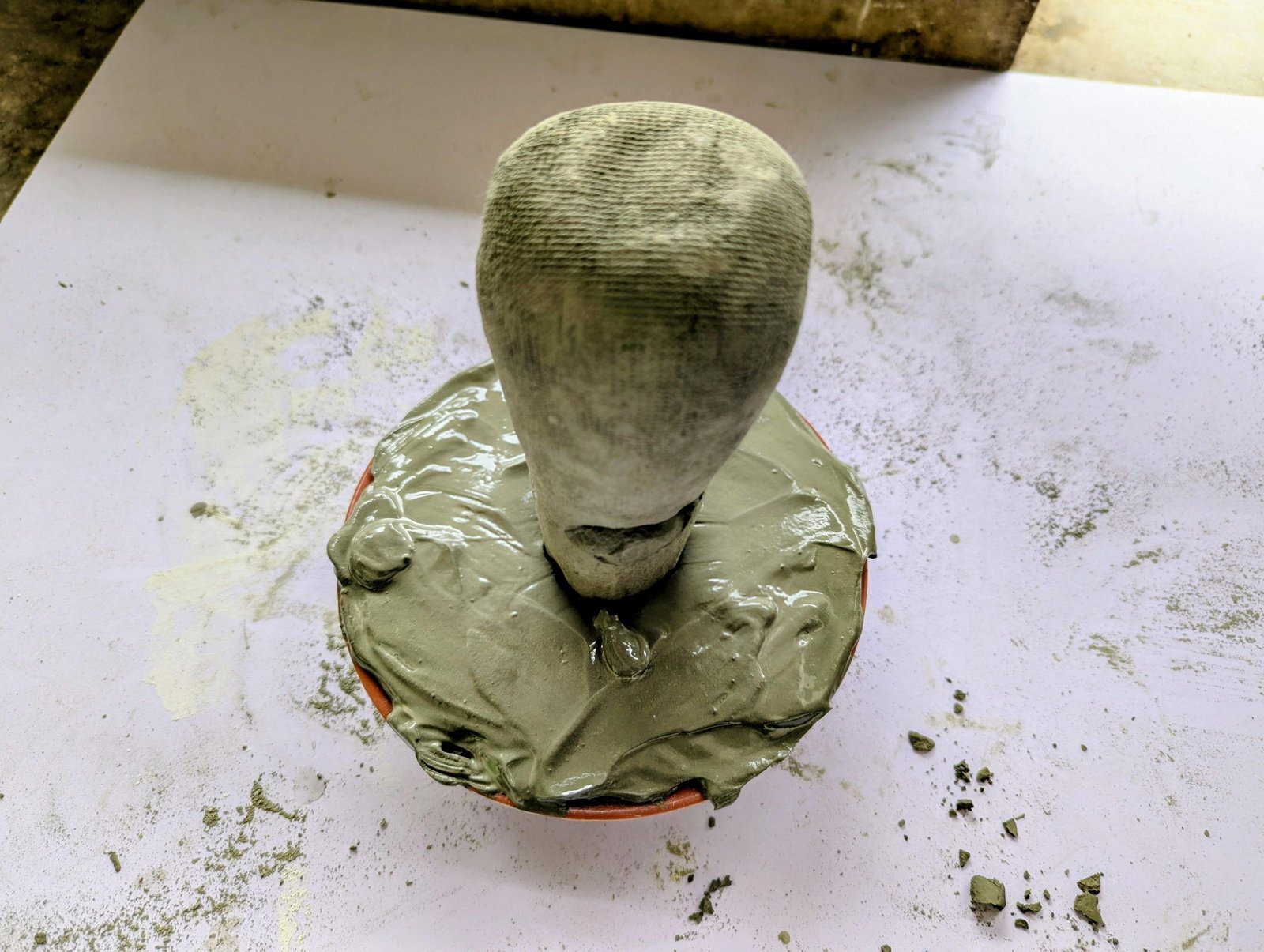 Cement mushroom stem inserted upright into the center of the wet cap