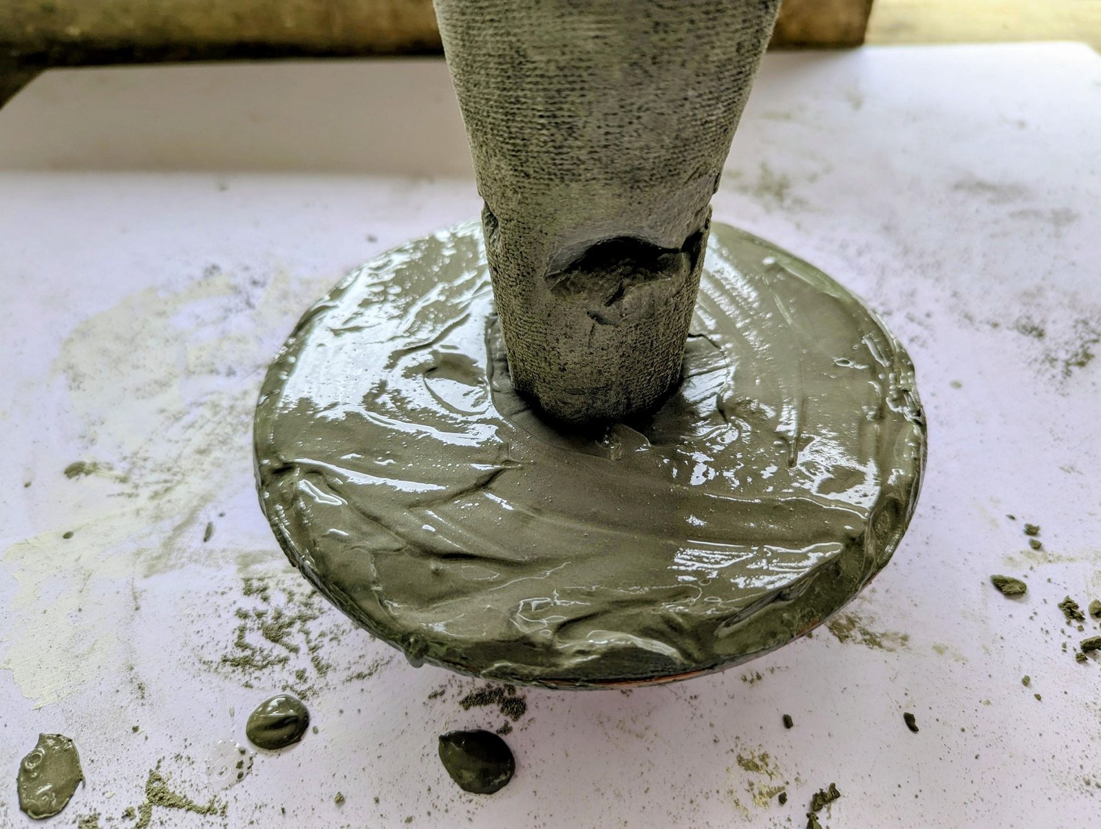 Large stem embedded in the wet cap before the underside is textured