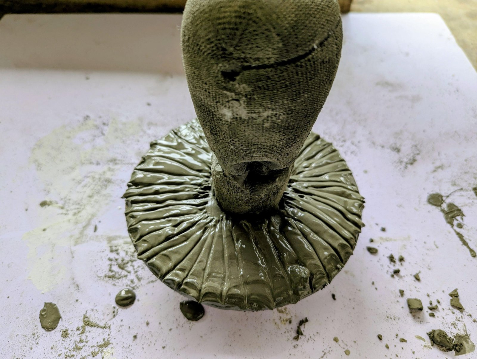 Radiating gill grooves being carved into the soft cement cap