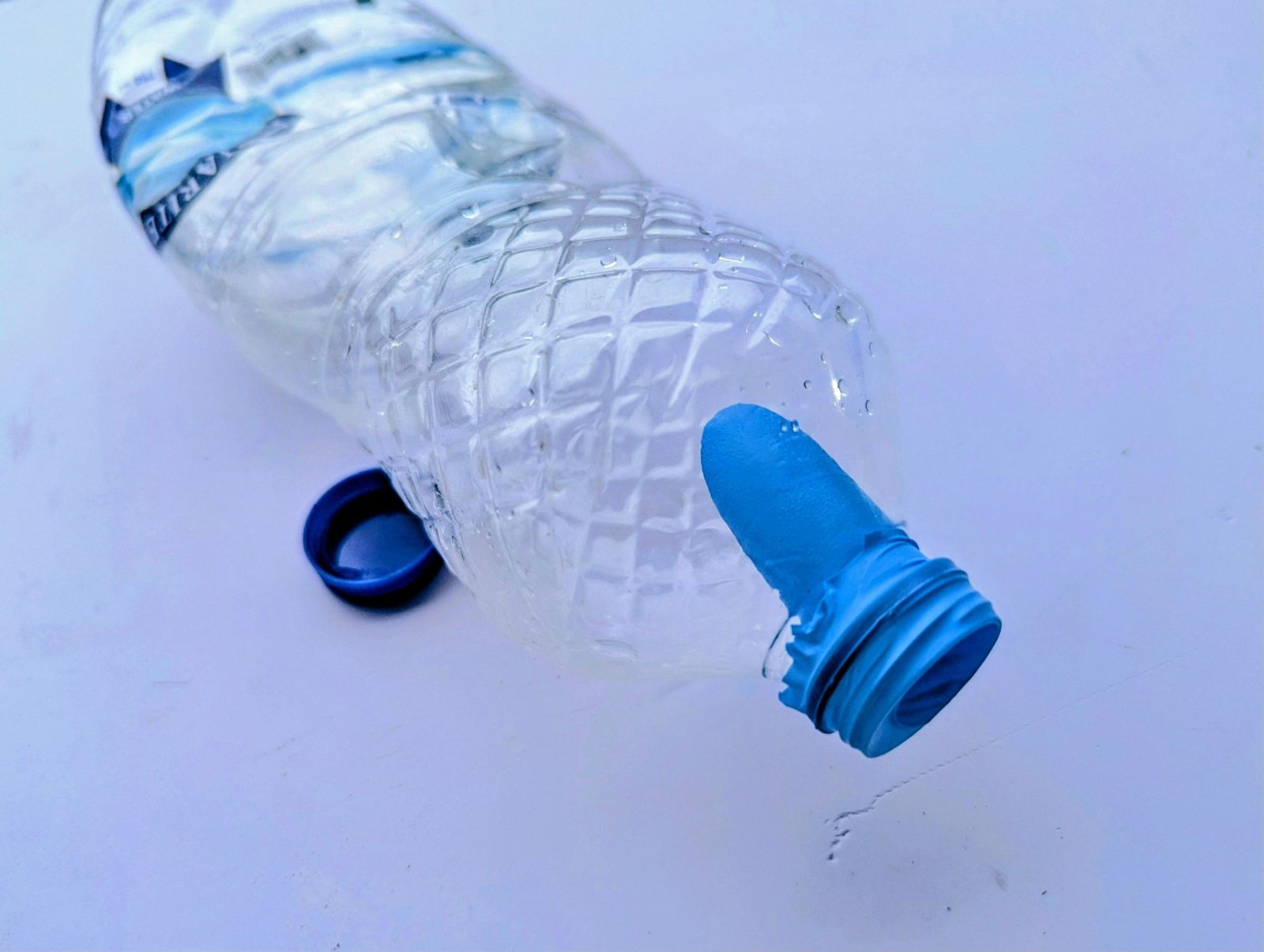 Rubber-glove finger stretched over a bottle opening to prepare a small stem mold
