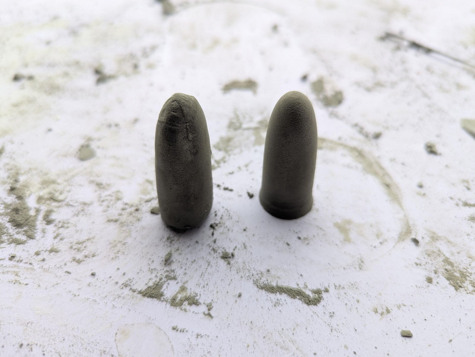Two cured miniature cement stems removed from their glove molds