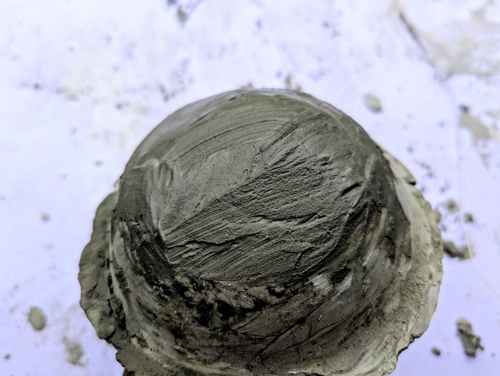 Fresh cement built over the center of the large cap to form a dome