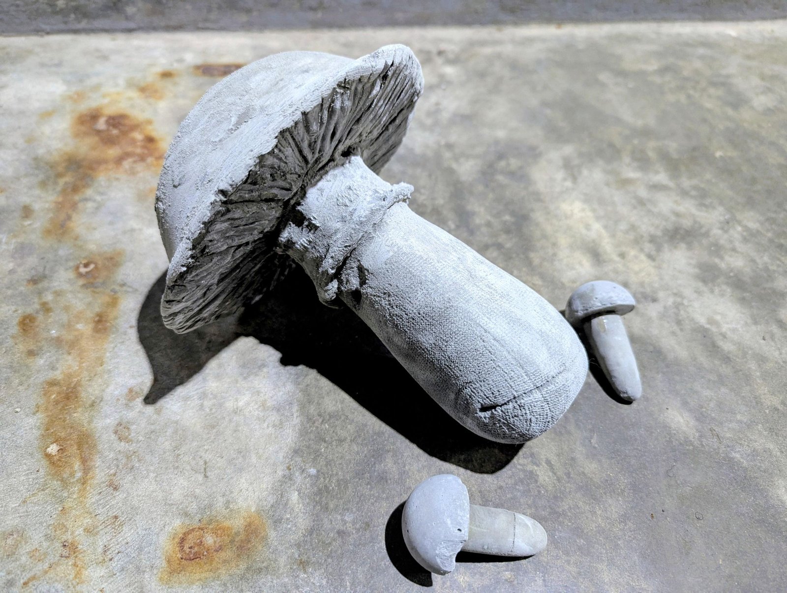 Large and small cement mushrooms after the first pale base coat