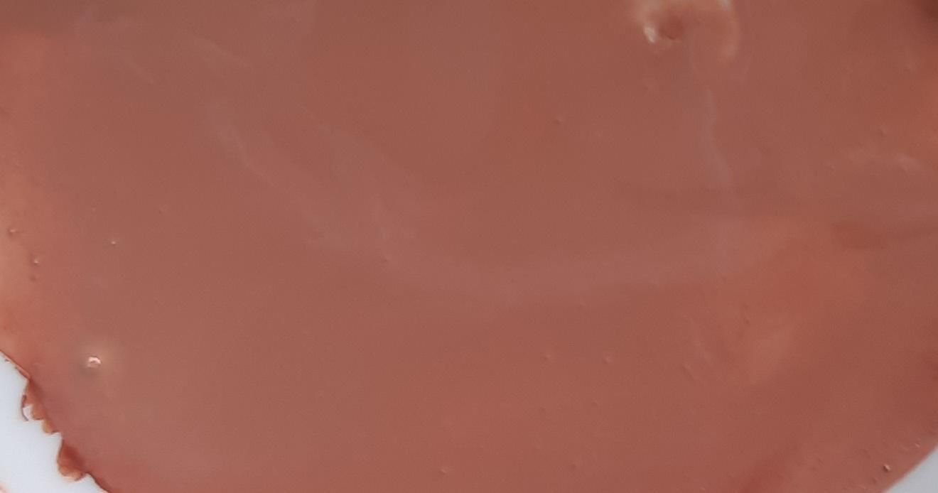 A warm brown paint mixture spread across a palette