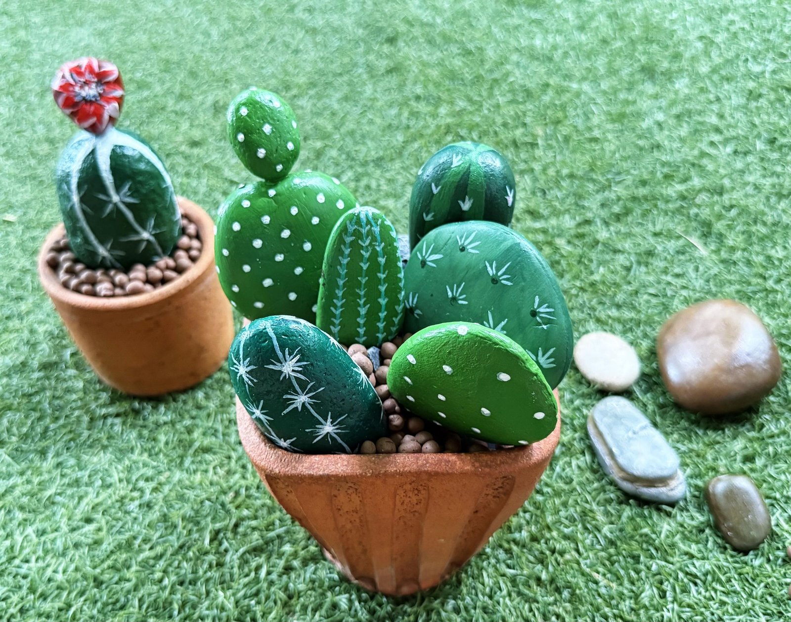 Two finished stone cactus planters displayed together on green grass