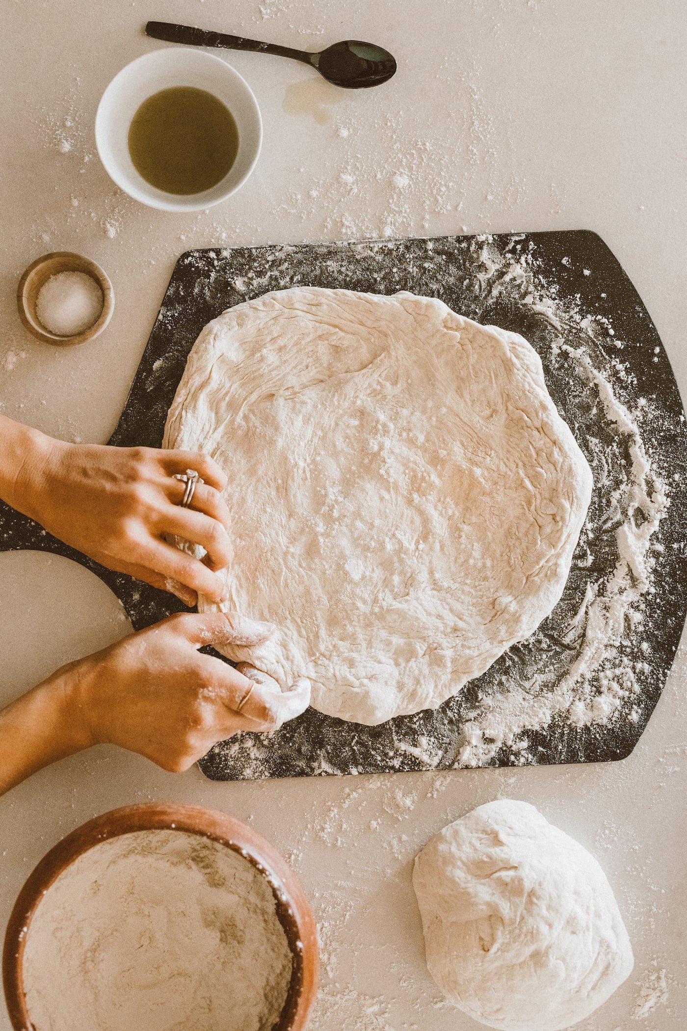 Rested pizza dough on a floured work surface