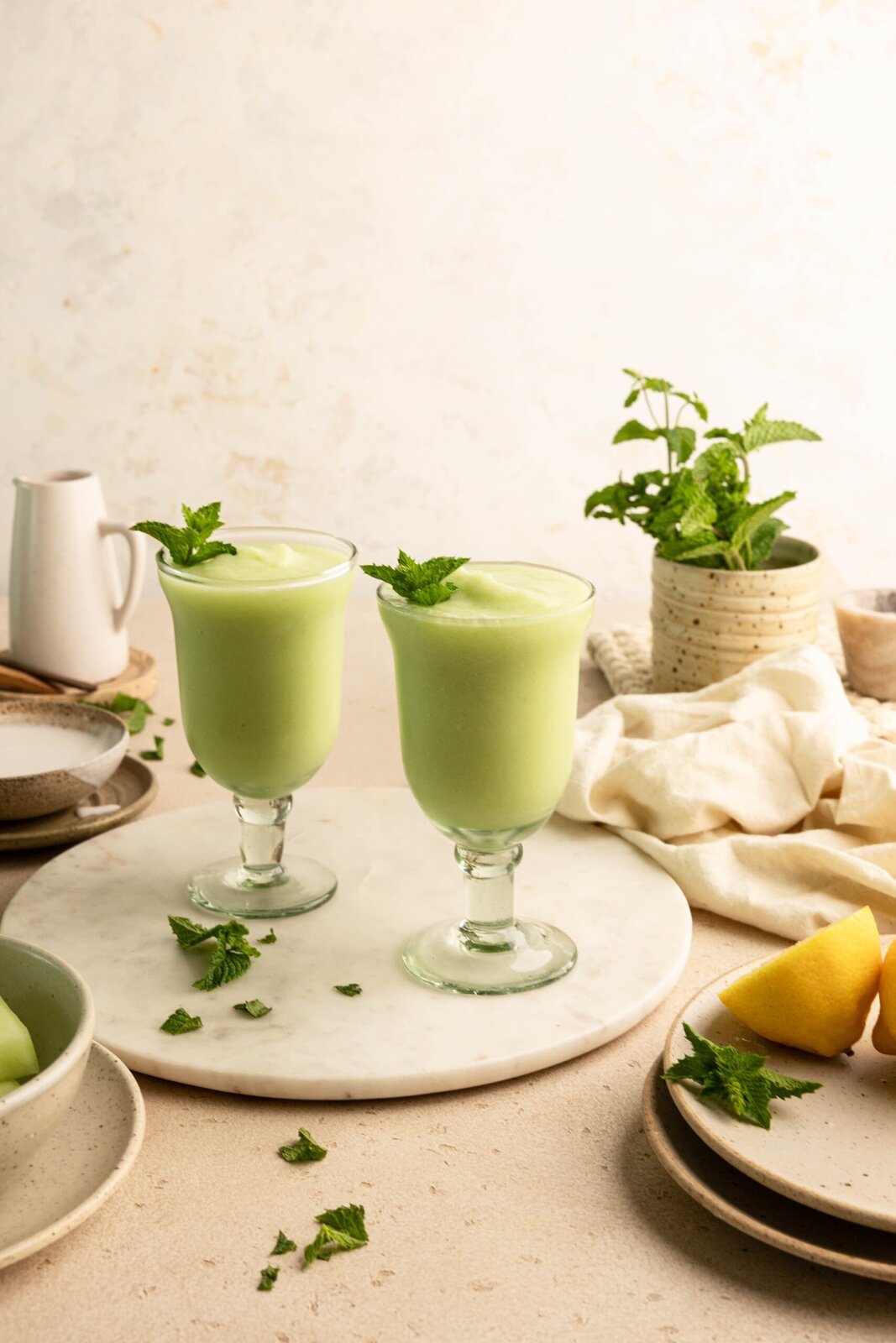 Honeydew melon slushies garnished with fresh mint