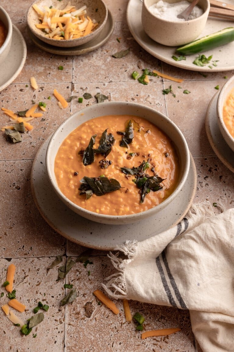 Tomato and lentil daal soup garnished with herbs