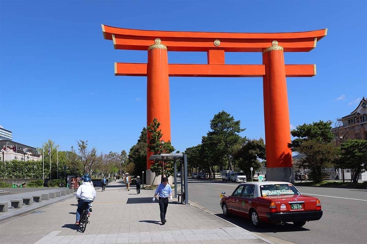Biking past a huge torii gate at Heian Shrine in Kyoto
